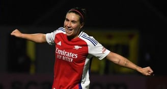a woman soccer player is celebrating a goal