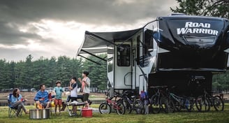 a group of people sitting around a campervan