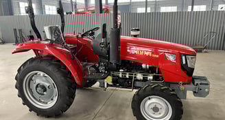a 70HP/4WD red tractor with a large wheel on it