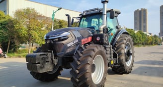 a 260HP/4WD tractor with a large tire on the side of the road