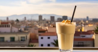 a glass of horchata with Valencia's skyline in the background