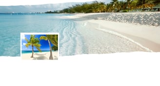 Vista panorâmica de Grand Cayman com mar cristalino, faixa de areia clara e vegetação tropicall.