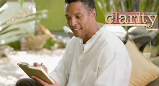 a man in a white shirt is holding a journal