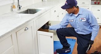 Plumber using Garbage Disposal