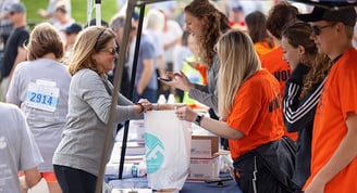a photo of a runner completing their packet pickup to receive their race number