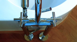 a bathroom with a Dornbracht tub and teak floor
