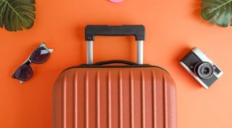 a suitcase with sunglasses and sunglasses on a table