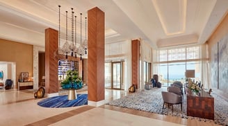 Ocean-inspired mural bespoke art by Lumai Studio anchoring reception interior at Fairmont Taghazout 