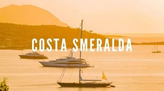 Luxury yacht illuminated by the golden light of sunset on the emerald sea of Sardinia’s northeastern