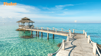 a pier with a thatched hut with a thatched roof in Phuket