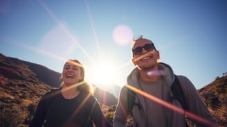 a man and woman walking down a mountain