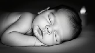 a baby sleeping on a bed
