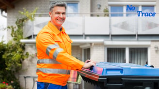 a man in a safety vest holding a blue bin