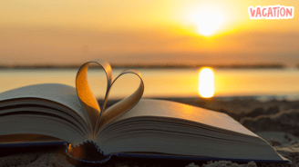 a book with a heart shaped bookmark on it during sunset