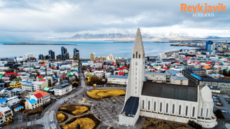 a tall tower with a clock tower in the middle of a city