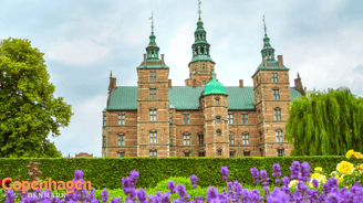 a castle like building with a green roof and a green roof