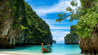 a boat in the water near a cliff