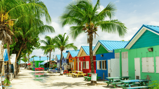 a row of colorful beach huts in the sand