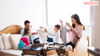 a family of four people packing suitcases
