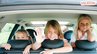 three girls sitting in the back of a car