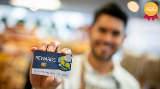 a man holding a reward card