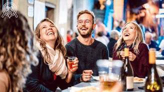 a group of people sitting at a table with drinks