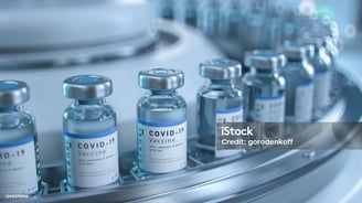 a row of vials filled with vaccines
