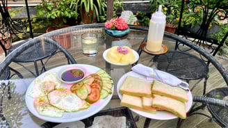 a table with a plate of food and a drink
