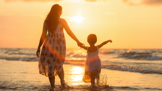 mother running with daughter on the beach