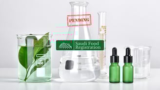 Glass labware with plant extracts and droppers labeled “Pending” under Saudi Food Registration review for product testing.