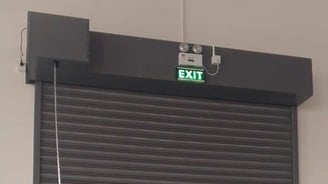 a garage door with a exit sign and exit sign