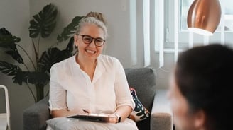 a woman sitting on a couch in a living room