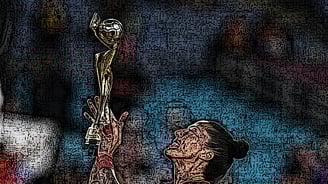 a woman holding a trophy in front of a wall