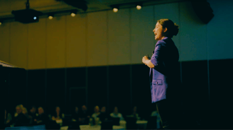 Fun Motivational Speaker Evelina Bereni on stage