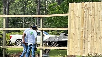 Remodeling professionals working on renovating the wooden fence, carpentry