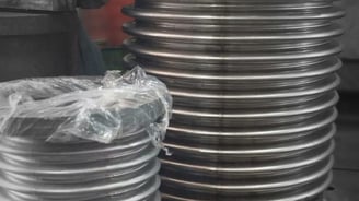 a stack of metal plates with a large metal object