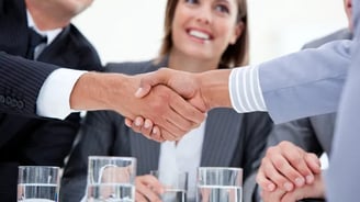a business meeting with a handshake of two people