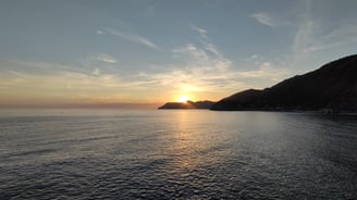 Sunset over mountain and water
