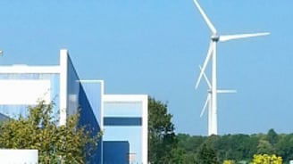 a gated in area with a fenced in area with a wind turbine