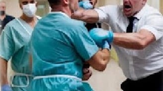 a doctor wearing a scrub attaccked by a patient in the hospital