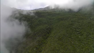 view of a mountain in clouds