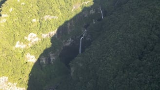 a succession of waterfall in the middle of a mountain