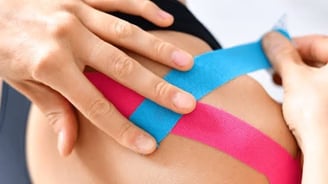 Kinesiology taping for sports injury recovery by physiotherapist