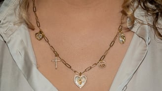 a woman wearing a necklace with a cross on it