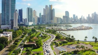a city skyline view of a city with a river and a city in the background