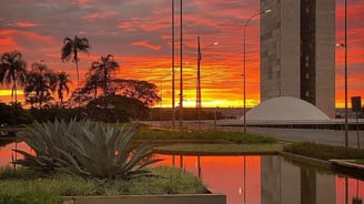 a sunset sky with a red sky and a building