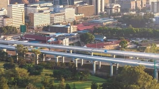 a city skyline view of a bridge over a river