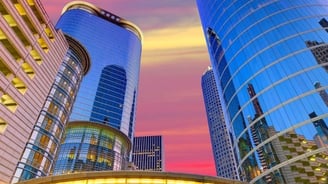 a city street scene with a colorful sunset