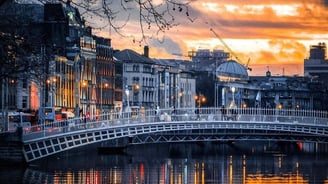 a bridge over a river with a bridge in the background