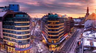 a city street scene with a train on the tracks
